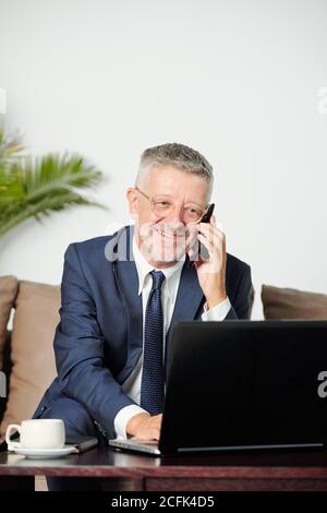 Smiling businessman calling on phone Stock Photo