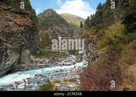 A double suspension bridge over the Dudh Koshi river on the way to Namche Bazar. Stock Photo