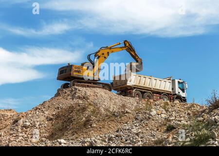 loader and truck on construction site Stock Photo