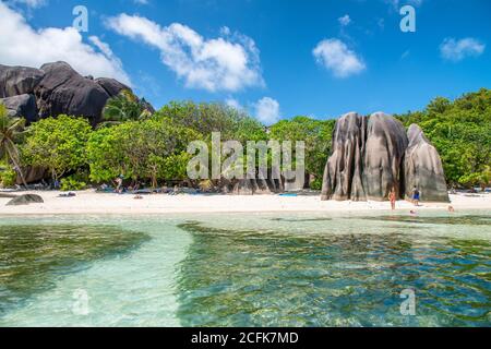 LA DIGUE, SEYCHELLES - SEPTEMBER 11, 2017: Tourists relax on the beautiful Source Argent Beach on a sunny day. Stock Photo