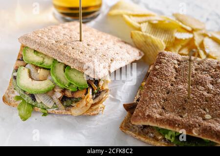 Closeup of freshly prepared sandwich with vegetable cutlet placed on table in cafe for lunch Stock Photo