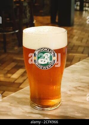 Seoul, South Korea - A glass of draft beer of Brooklyn Brewery. Draught beer from a pressurized keg using a lever-style dispenser. Stock Photo