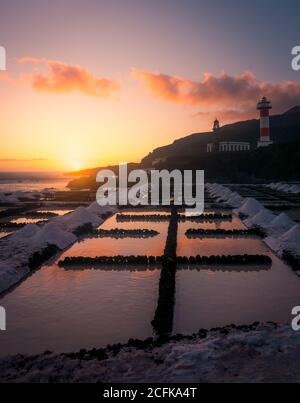 Frozen water and snow on background of spectacular seascape at sundown in winter Stock Photo