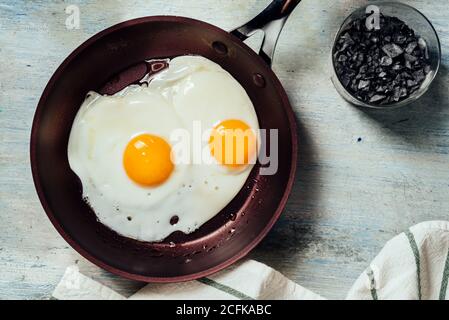 Fried egg. view of two fried eggs on a frying pan. ready to eat with breakfast or lunch Stock Photo