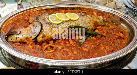 Big fish with tomato sauce. Spanish cooking Stock Photo