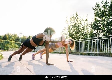 Group of five women in sportswear with fitness accessories