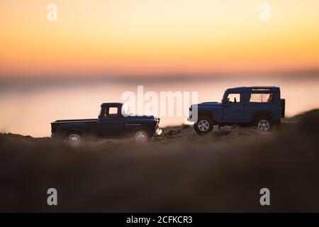 Izmir, Turkey - August 22, 2020: Close up shot of a Chevrolet 3100 pickup truck and a Blue colored land rover Suv vehicle on sand and on sunset. Stock Photo