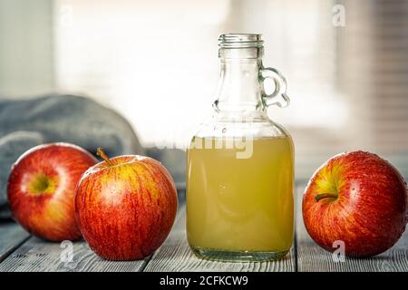 Unlit freshly squeezed Apple juice. New crop of apples. Freshly washed fruit on the table. Healthy diet. Stock Photo
