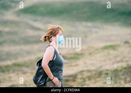 Mature traveler Woman in profile with medical face mask Stock Photo