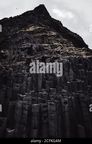 Dramatic basalt columns on a dark day at Reynisfjara black sand beach near Vik, Iceland Stock Photo