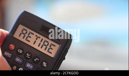 Retire word on calculator display. Retirement career business concept Stock Photo