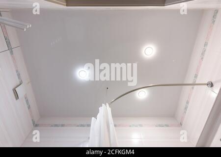 Stretch ceiling with three spotlights in the bathroom Stock Photo