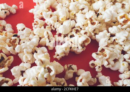 Close up popcorn on color red background Stock Photo
