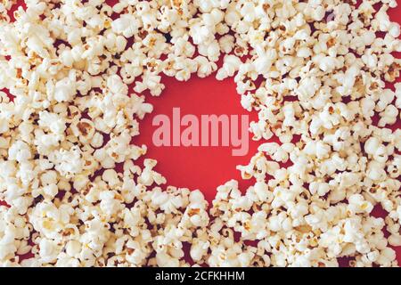 Spilled popcorn on a red background, cinema, movies and entertainment concept Stock Photo