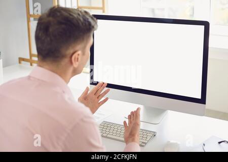 Man using personal desktop computer for teleconference communicating his ideas during video call Stock Photo