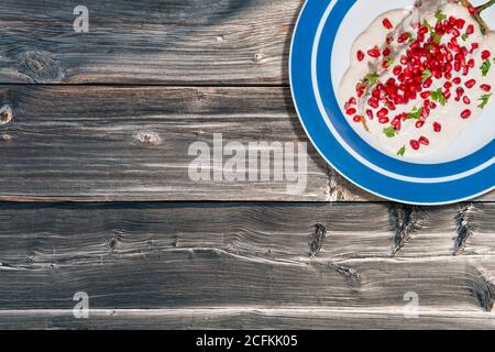 Top view of chiles en nogada, traditional festive dish on Mexican Independence Day. Green chili peppers with walnut sauce, common food for Mexico, in Stock Photo