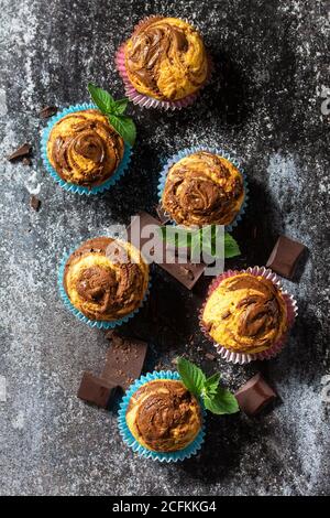 Muffins with chocolate and mint on the background of dark slate. Top view flat lay background. Stock Photo