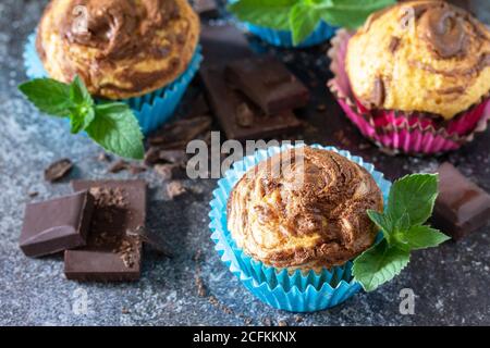 Muffins with chocolate and mint on the background of dark slate. Stock Photo