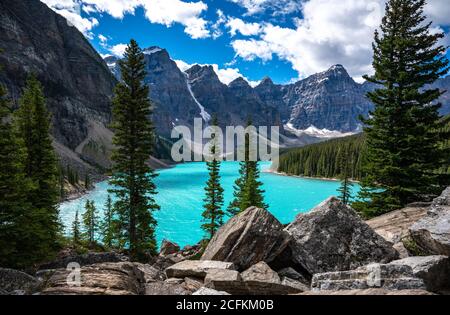 Moraine Lake with rocky foreground mid day. Stock Photo