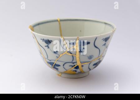 Kintsugi tea bowl ceremony chawan. Gold cracks restoration on old ...