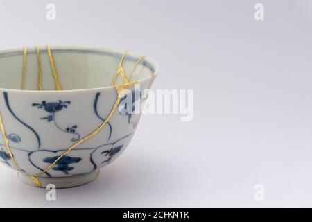 Kintsugi tea bowl ceremony chawan. Gold cracks restoration on old ...