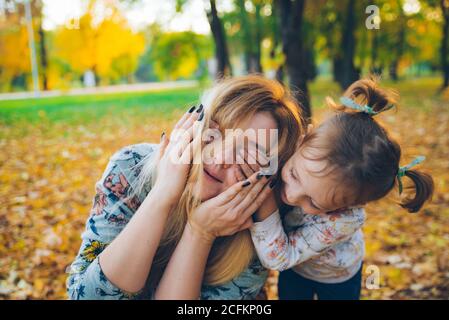 guess who daughter close eyes to mother Stock Photo