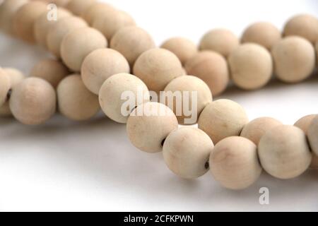 A beautiful string of wooden beads isolated on a white background Stock Photo