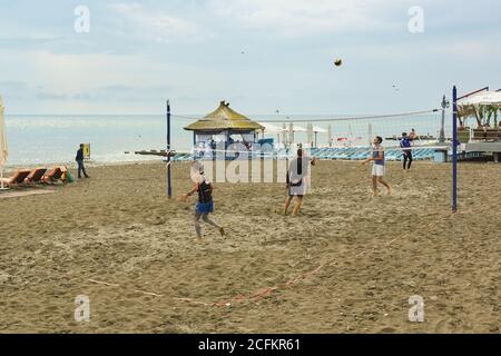 Sochi, Krasnodar Krai, Russia - June 07.2017: Young people playing beach volleyball on the sand by the sea Stock Photo