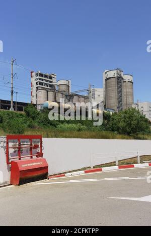 Russia, Krasnodar region, Verkhnebakansky settlement - June 12, 2018: production facilities of Verkhnebakansky cement plant from LUKOIL gas station. S Stock Photo