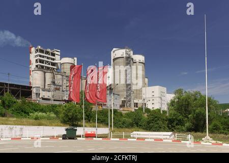 Russia, Krasnodar region, Verkhnebakansky settlement - June 12, 2018: production facilities of Verkhnebakansky cement plant and red flags of LUKOIL ga Stock Photo