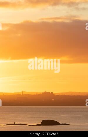 Sunrise over Edinburgh Castle seen from Dalgety Bay, Fife, Scotland. Stock Photo
