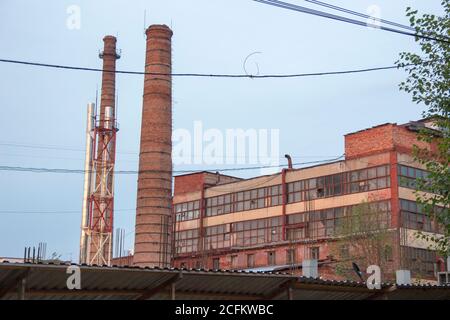 Factory pipes made of red brick, industrial landscape. Stock Photo