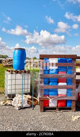 Chemicals in plastic containers at a dump site. Stock Photo