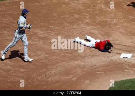 Cleveland, United States. 06th Sep, 2020. Milwaukee Brewers Christian Yelich (22) runs by Cleveland Indians Jose Ramirez (11) laying on the ground at second base after being tagged out by Milwaukee Brewers Keston Hiura in the third inning at Progressive Field in Cleveland, Ohio on Sunday, September 6, 2020. Photo by Aaron Josefczyk/UPI Credit: UPI/Alamy Live News Stock Photo