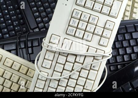 The problem of consumer electronics waste. Worn computer keyboards. Stock Photo