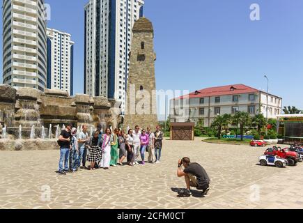 Grozny, Chechen Republic, Russia - June 02, 2019: a Group of tourists are photographed against the backdrop of decorative towers and high-rise buildin Stock Photo