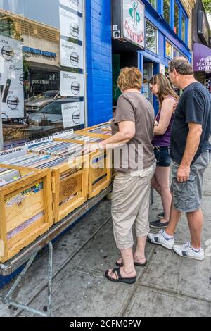 People looking in the bargain bin of vinyl records outside Easy Street Records in West Seattle. Stock Photo