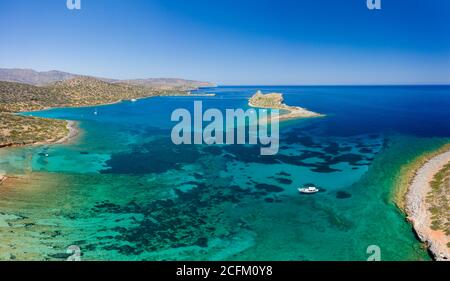 Aerial view of the coastline of Crete surrounded by the clear waters of ...