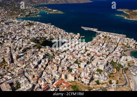 Aerial view of the picutresque town of Aghios Nikolaos in Crete (Greece) surrounded by crystal clear ocean Stock Photo