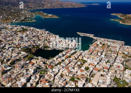 Aerial view of the picutresque town of Aghios Nikolaos in Crete (Greece) surrounded by crystal clear ocean Stock Photo