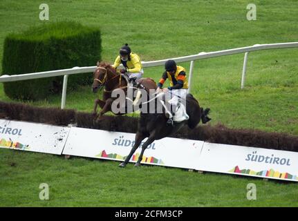 Horses at a race getting over an obstacle on Sept. 6th of 2020 in Merano, Italy. Stock Photo