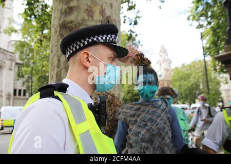 London, UK. 06th Sep, 2020. Extinction Rebellion protestors march from Parliament Square to Tate Modern to highlight the dangers to marine life from global warming and climate change, 6th September 2020. Protestors face police on parliament square Credit: Denise Laura Baker/Alamy Live News Stock Photo