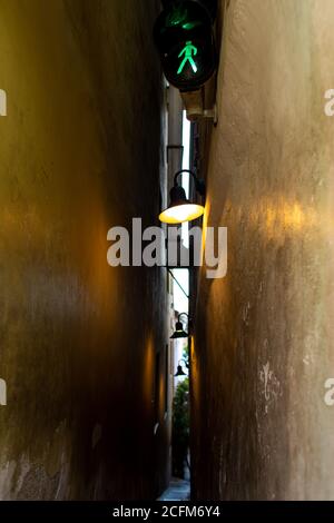 The architecture of the strago city of Prague. The narrowest street in Europe. The passage between buildings for one person, regulated by traffic ligh Stock Photo
