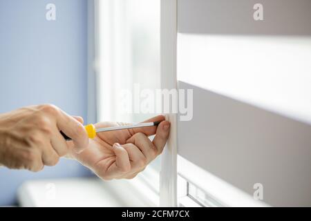 The man is repairing the plastic window Stock Photo