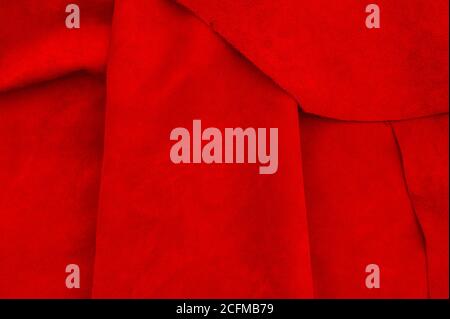 Dark red matte background of suede fabric, closeup. Velvet texture of seamless wine leather. Felt material macro. Stock Photo