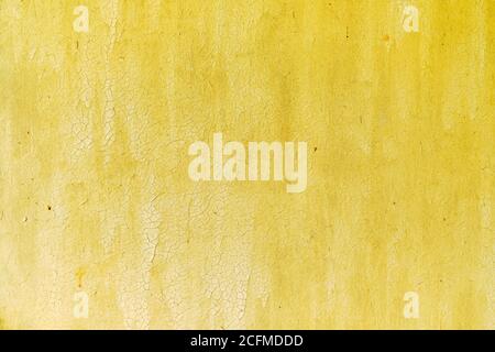 Plywood wall texture with old cracked yellow paint. Stock Photo