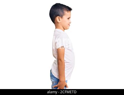 Teenager boy wearing casual t-shirt standing over blue isolated background  looking to side, relax profile pose with natural face and confident smile.  Stock Photo | Adobe Stock