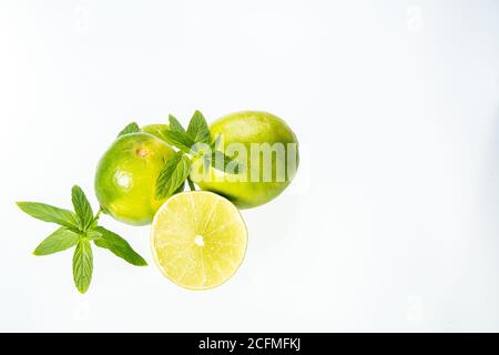 Group of lemons with mint leaves, isolated on white background Stock Photo