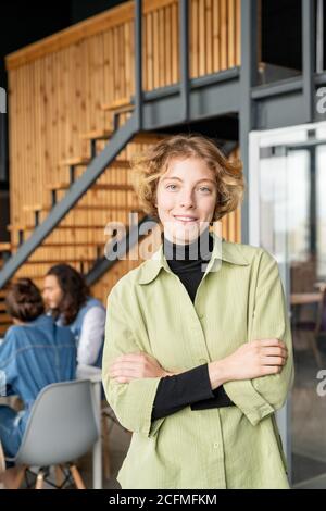 Young pretty blond female programmer in casualwear standing in front of camera Stock Photo