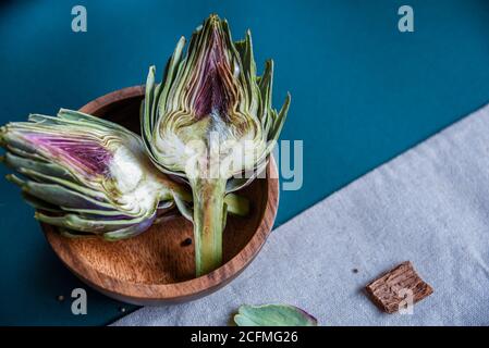 Fresh artichokes hearth on wooden plate Stock Photo